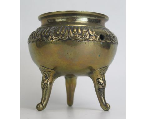 A Chinese bronze tripod censer, of circular form raised on three swept legs. 13cm diameter.