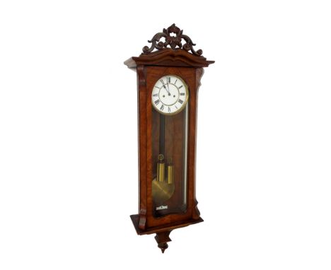 Walnut double weight Vienna regulator wall clock, the 7" white dial within a glazed canted case surmounted by a pierced folia