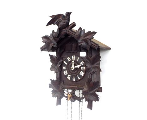 Black Forest cuckoo and quail wall clock, the 5.25" dial within a chalet style case applied with carved vine leaves and game,