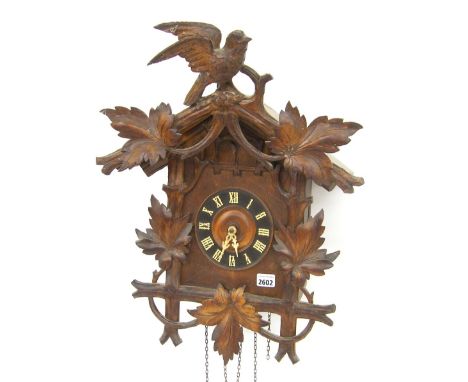 Black Forest carved cuckoo and quail triple weight wall clock, the 5" wooden dial within a typical carved gable case (pendulu