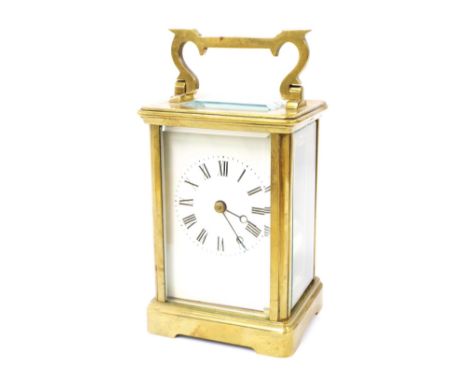 Carriage clock timepiece striking on a gong, the white dial within a corniche brass case, 6" high