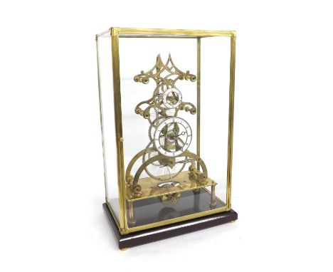 Reproduction single fusee multi-wheel skeleton clock, under a glazed brass framed case and upon a wooden plinth, 24" high ove