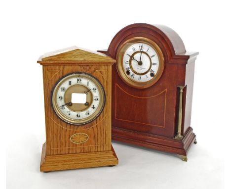 Oak two train mantel clock striking on a gong, the 3.75" white chapter ring enclosing a recessed gilded centre, within a step