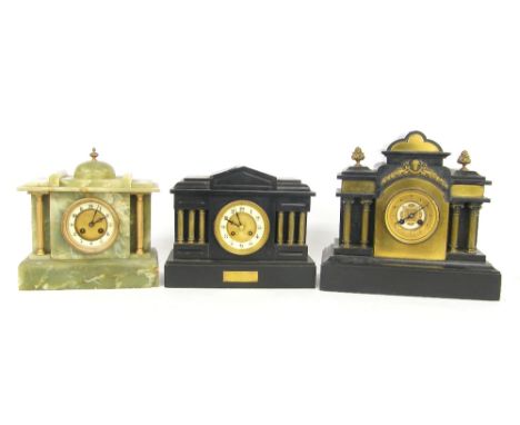 Two similar black slate two train temple case mantel clocks, 13.75" and 10.25" high; together with a similar green onyx two t