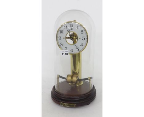 Bulle electric mantel clock, the 5.25" white dial supported upon a cylindrical brass battery column, under an associated glas