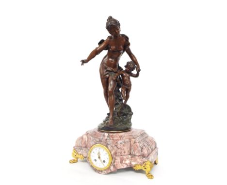 French bronzed and pink marble two train figural mantel clock, the movement striking on a bell, the 3.5" painted white dial i