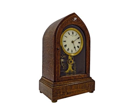 Oak Eureka lancet mantel clock, the 4.25" circular dial signed Eureka Clock Co. Ltd., London above the exposed movement, insc