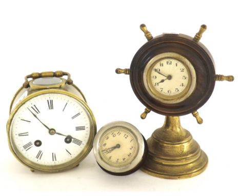 Eight day drumhead mantel clock with visible platform escapement, the 3.75" white dial within a brass case surmounted by a ca