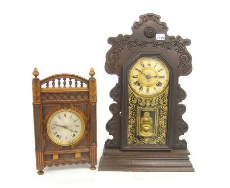 German oak two train mantel clock striking on a gong, the 4.25" silvered dial within a decorative carved case, 15" high; toge