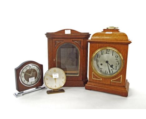 Oak two train mantel clock striking on a gong, the 5.75" silvered dial within a panelled stepped case surmounted by a caddy t