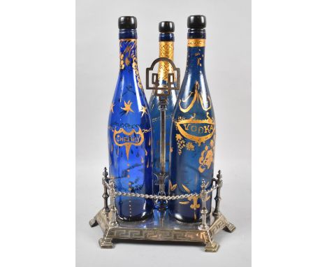 An Edwardian Silver Plated Three Bottle Tantalus Stand with Rope Twist Gallery Containing Three Hand Painted Blue Glass Bottl
