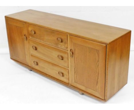 An Ercol light elm sideboard, the three central drawers flanked by two cupboards, 68cm high, 153cm wide, 43cm deep.