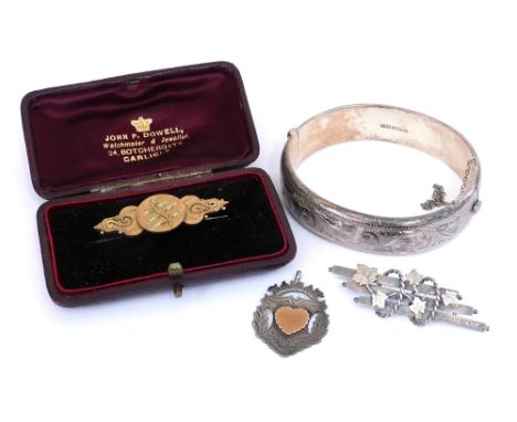 A silver bangle with engraved decoration, on a snap clasp with safety chain as fitted, Victorian yellow metal brooch with a f