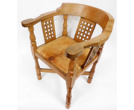 A Robert Thompson Mouseman oak monk's chair, with a curved back and shaped arms, over three lattice work panels, with a studd