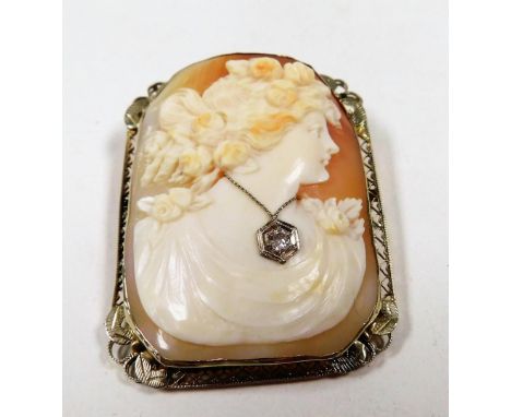 An early 20thC American shell cameo brooch, bust portrait of a lady, wearing a real diamond set necklace, in a yellow metal f