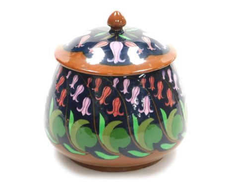 A Wileman and Co Foley Intarsio jar and cover, decorated with bluebells against a dark blue ground, with brown highlights, pa
