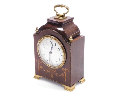 An Edwardian mahogany and inlaid mantel clock, the cream enamel dial bearing Arabic numerals, with brass ring handle, brass u