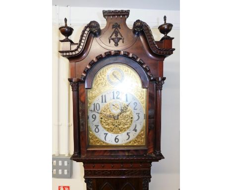 A Victorian mahogany longcase clock, the arched dial with applied elaborate floral and pierced decoration, surrounding a silv