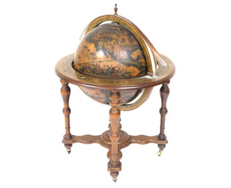 A 20thC terrestrial globe cocktail cabinet, mounted on an oak base with five turned supports, on a X shaped stretcher, on bra