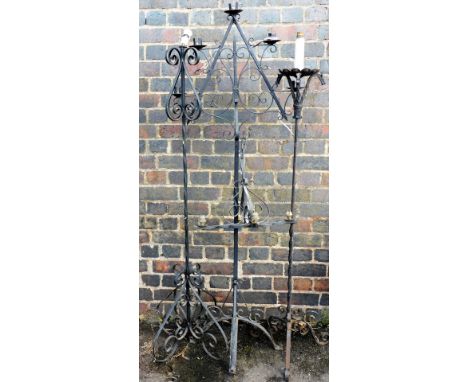 A group of painted wrought metal standard lamps and candle holders, and a four branch light fitting. 