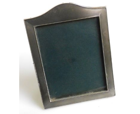 An Elizabeth II silver strut photograph frame, with shaped top of rectangular form, engine turned decoration, Birmingham 1961