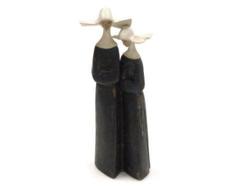 A Lladro matte porcelain figure group of two nuns, printed and impressed marks, 34cm high. 