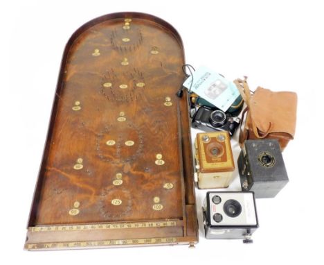 An early 20thC oak bagatelle board, a quantity of cameras, to include a Kodak Brownie model 1 camera, a Brownie SIX-20 model 