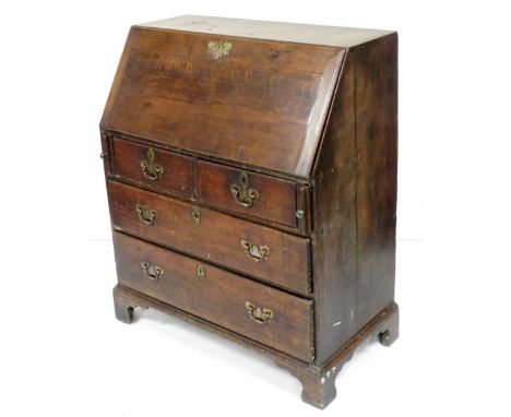 A George III oak bureau, the fall enclosing a fitted interior of five recesses over nine drawers, above two short and two lon