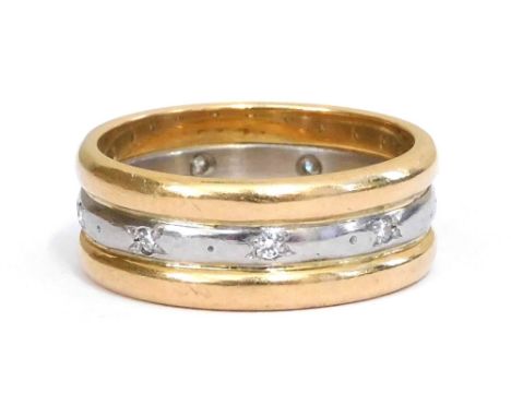 A diamond set triple wedding band, grain set in white and yellow metal, stamped platinum, size K/L, 6.7g. 