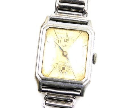 A mid century Rotary gentleman's stainless steel cased tank wristwatch, the canted rectangular yellow metal dial bearing Arab