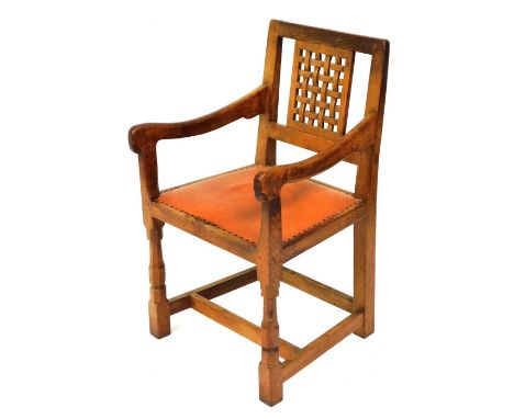 A Robert Thompson Mouseman oak carver chair, with lattice work panel back, a studded leather seat, on octagonal carved and bl