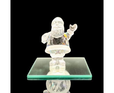 A clear crystal figure of Santa Clause with frosted crystal accents and blue crystals for the eyes along with a square reflec