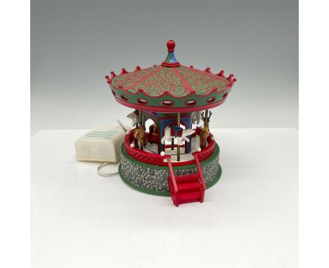 Part of the Village Accessories collection. A musical hand painted porcelain figure of a Christmas carousel. Department 56 ma