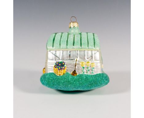 Glorious and meticulously hand-painted , this ornament captures the charm of a garden greenhouse, adorned with vibrant flower