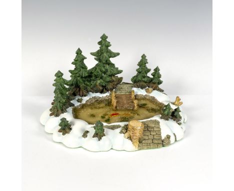 A serene woodland scene, featuring a charming pond teeming with fish, a rustic dock, and tranquil pine trees. Department 56 m
