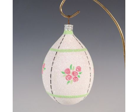 Exquisitely hand-painted glass ornament depicts a charming array of roses, thin stripes, flowers, and shades of green, white,