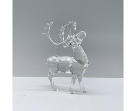 A clear reindeer figurine, standing gracefully on all fours with its head gently raised and adorned with melon-colored eyes. 