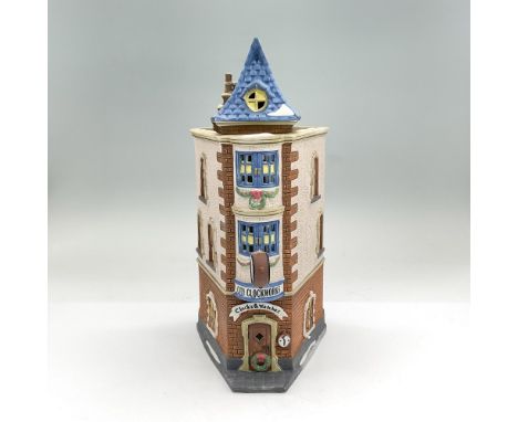 Handpainted matte porcelain three-story building with a clock on the front. Part of the Christmas in the City Village Series.