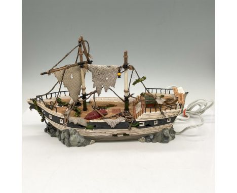 Spooky shipwreck on rocks with tattered sails, weathered and damaged deck. When plugged in light illuminates the windows and 