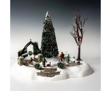 Complete outdoor holiday scene including pond, decorated tree, snow, skaters, bushes and walls. Department 56 sticker. 5247-7