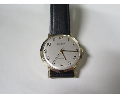 A gentlemans Bulova Longchamp 9ct gold wristwatch, hallmark London 1975 - with engraved presentation text to back, see images