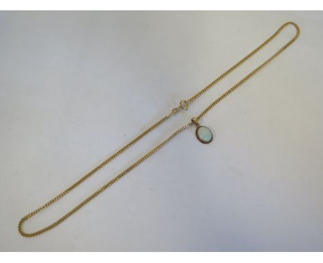 A hallmarked 9ct yellow gold opal pendant on a 9ct chain - 46cm long, pendant 14mm x 10mm - in a clean condition, total appro