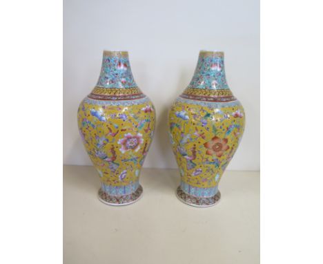 A pair of Chinese porcelain vases decorated with Phoenix and precious objects on a yellow ground, Daoguang marks to base but 