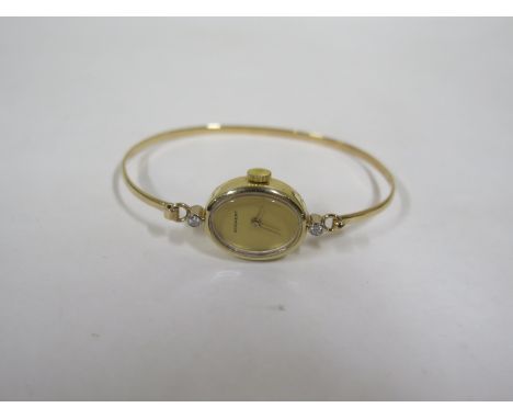 A Bogaert 9ct yellow gold manual wind ladies bangle watch set with two small diamonds, 17mm wide, including button, approx 10