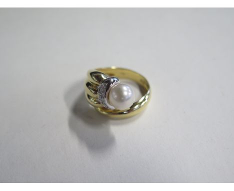 An 18ct pearl and diamond ring, approx 8.2 grams, some wear to band, size O 