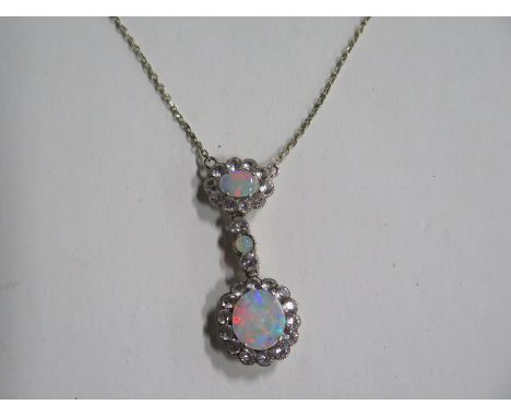 A 9ct white gold opal white stone necklace, rubbed 9ct mark to clasp, chain length approx 40cm, approx 4.9 grams, some wear b