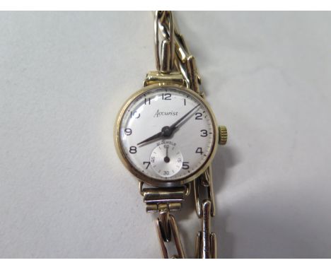 A 9ct yellow gold Accurist manual wind ladies watch with sprung strap, running order, some scratches, total weight approx 13 