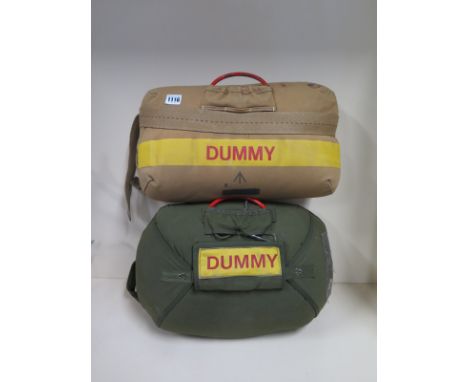 Two dummy parachutes, one in khaki with a brand arrow, the other in green, both with wear throughout 