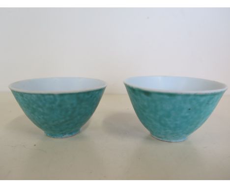 A pair of Chinese porcelain bowls decorated in a green glaze, 18th Century - small firing fault to base of one 