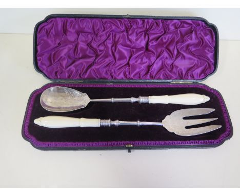 A pair of Victorian silver servers with carved ivory handles, London 1892/93 maker EH Edward Hutton 30cm long, some usage wea